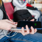 Woman hand connect power bank to smartphone