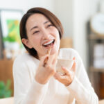 Middle-aged woman eating in the living room